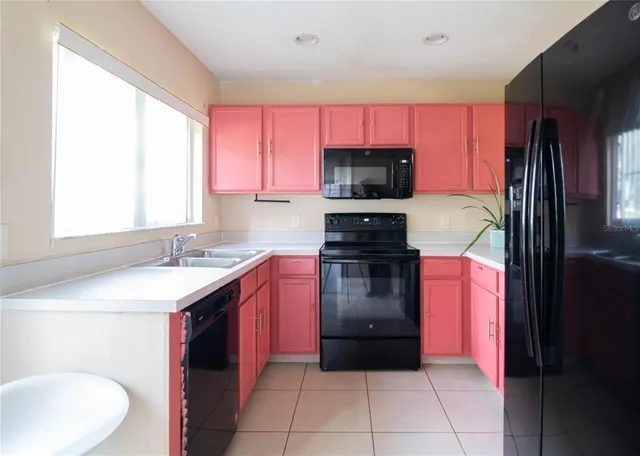 a kitchen with a sink stove and refrigerator