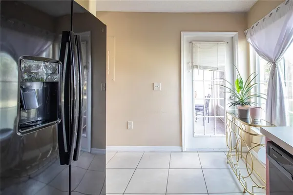 a kitchen with granite countertop a refrigerator and a sink