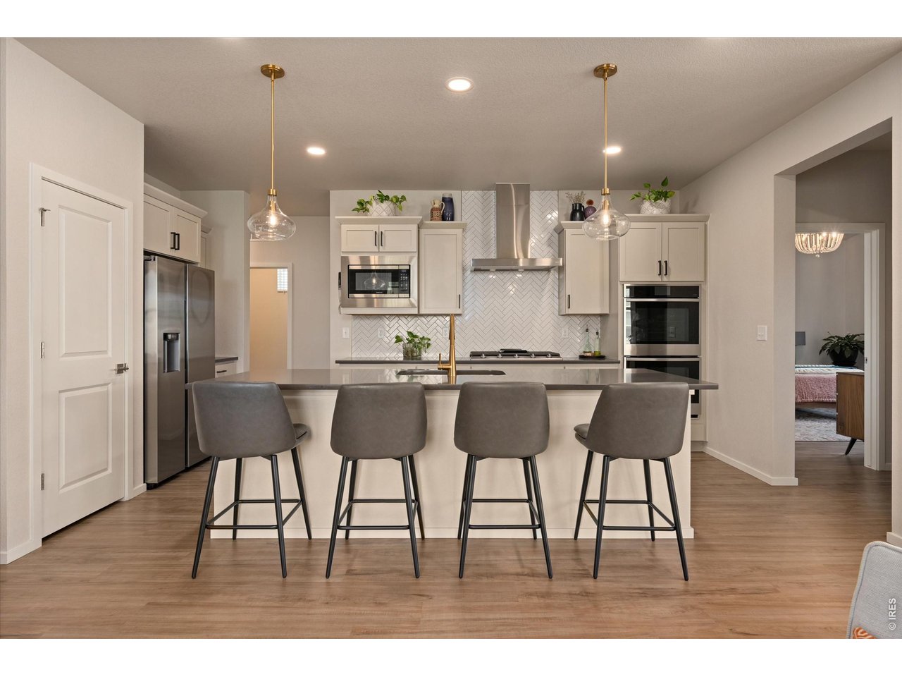 5251 Ribault Street Timnath, CO 80547 - Photo 11 of 47 Bright kitchen with full wall backsplash, gas range, and hood