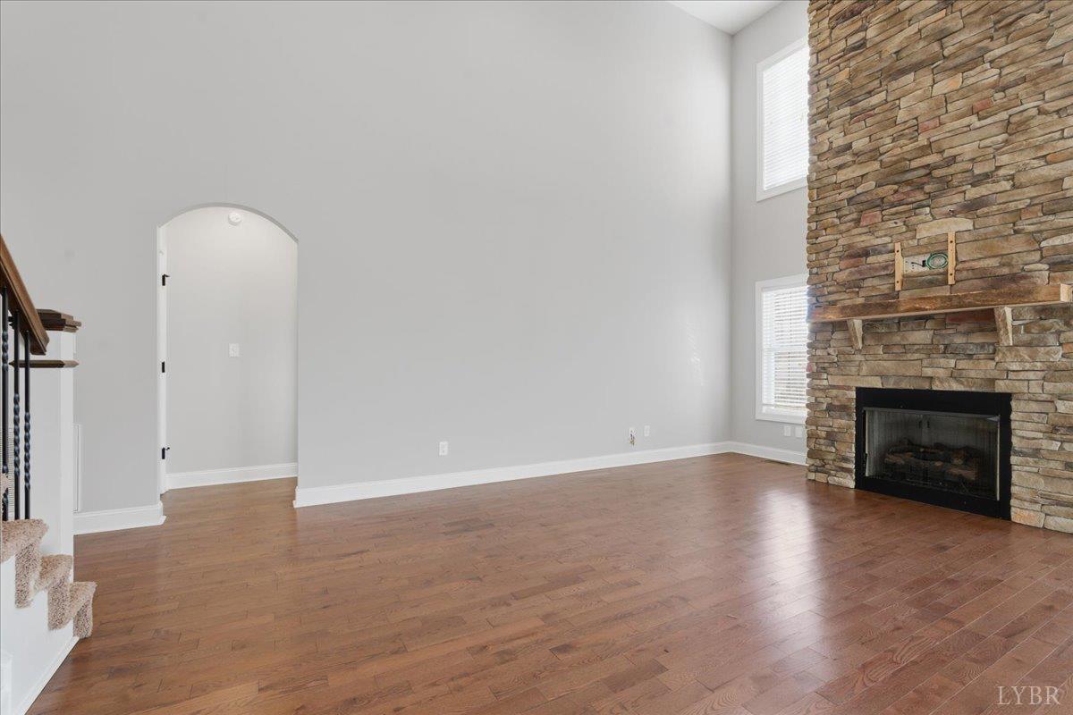 509 Cornerstone Street Lynchburg, VA 24502 - Photo 12 of 56 an empty room with wooden floor and fireplace