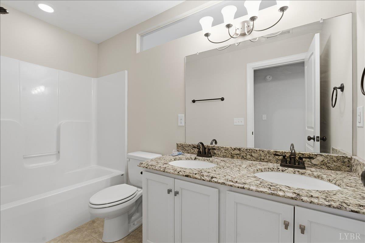 509 Cornerstone Street Lynchburg, VA 24502 - Photo 45 of 56 a bathroom with a granite countertop sink a toilet and a mirror