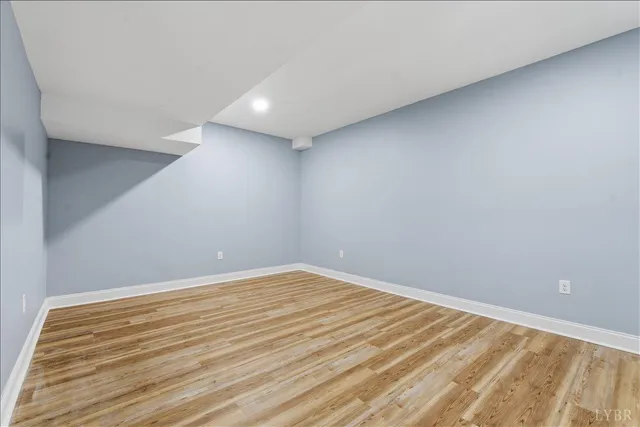 a view of hallway with stairs and wooden floor