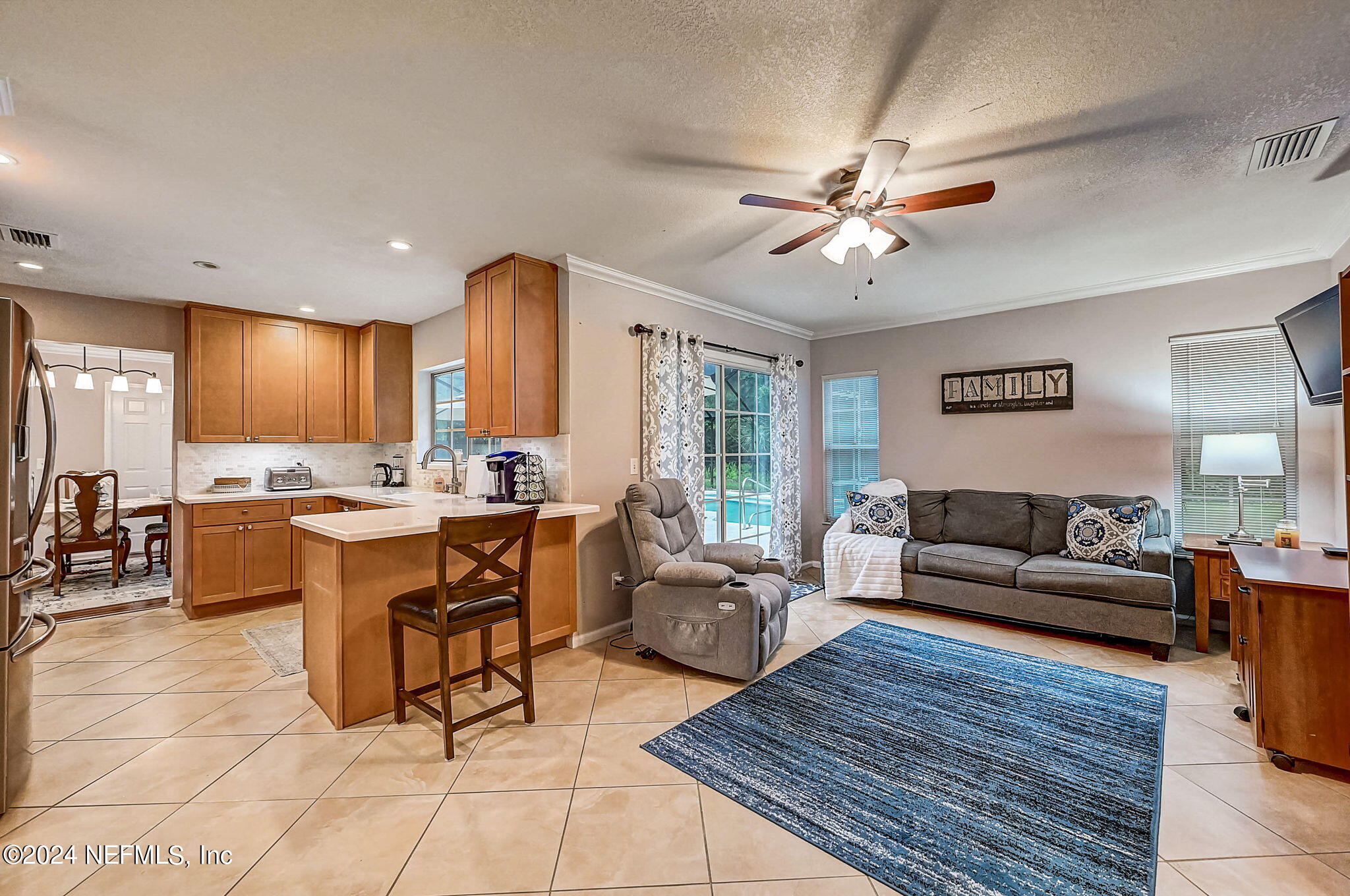 1130 Linwood Loop St. Johns, FL 32259 - Photo 12 of 34 a living room with furniture a ceiling fan and a dining table