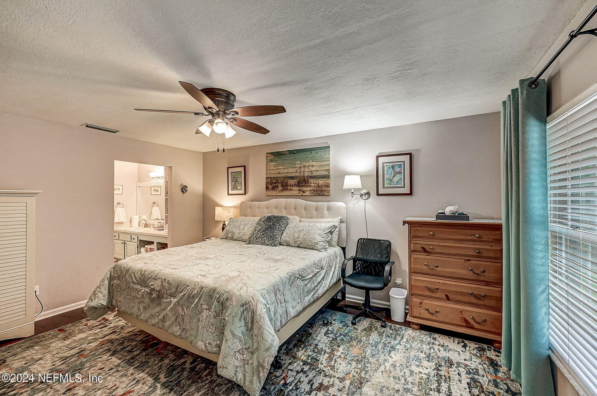 1130 Linwood Loop St. Johns, FL 32259 - Photo 15 of 34 a bedroom with a bed and a chandelier