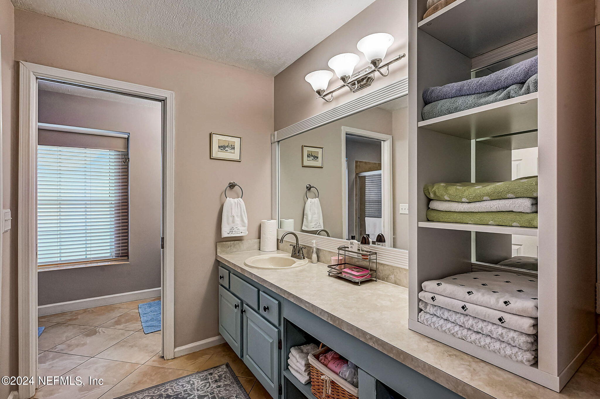 1130 Linwood Loop St. Johns, FL 32259 - Photo 16 of 34 a bathroom with a sink a vanity and a mirror
