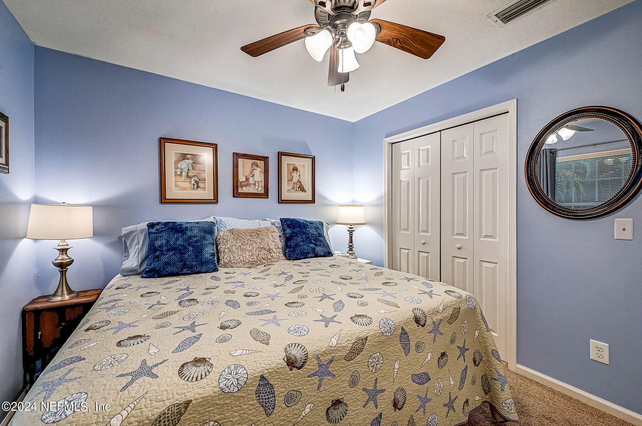 1130 Linwood Loop St. Johns, FL 32259 - Photo 25 of 34 a bedroom with a large bed and a chandelier