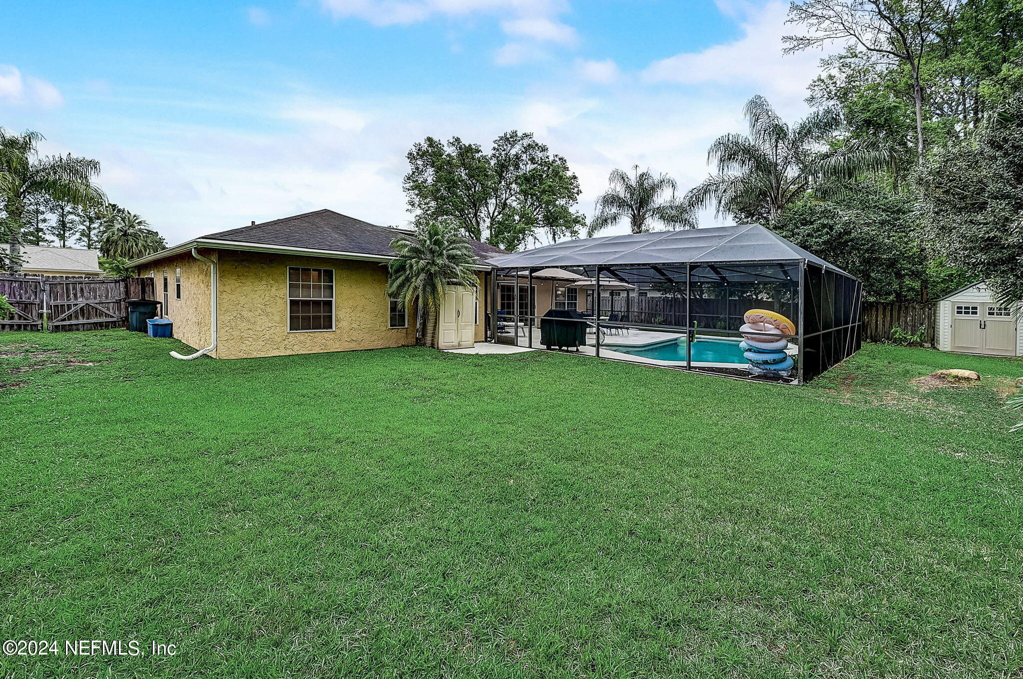 1130 Linwood Loop St. Johns, FL 32259 - Photo 32 of 34 a view of a house with a big yard and large trees
