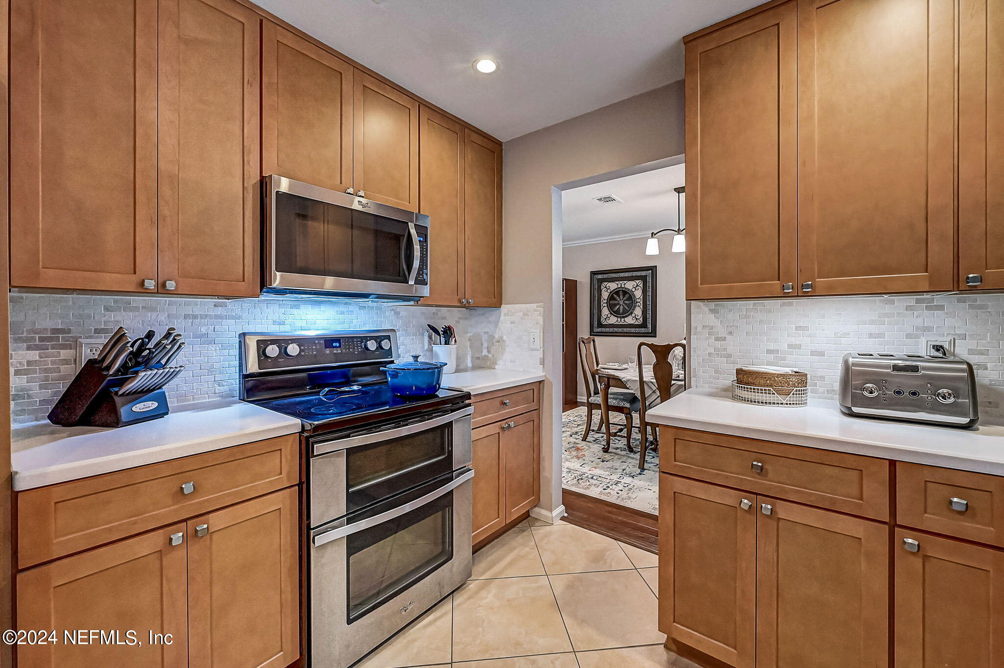 1130 Linwood Loop St. Johns, FL 32259 - Photo 9 of 34 a kitchen with stainless steel appliances granite countertop a stove a sink and a microwave
