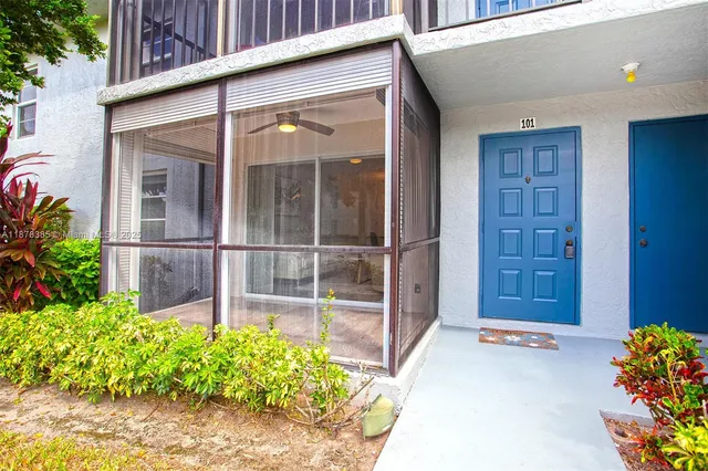 a kitchen with white cabinets and sink
