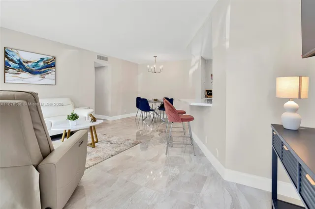 a living room with furniture a rug and white walls