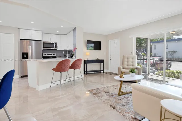 a bedroom with two beds and a window