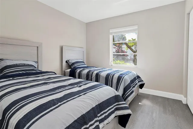 a bedroom with double bed and a shower