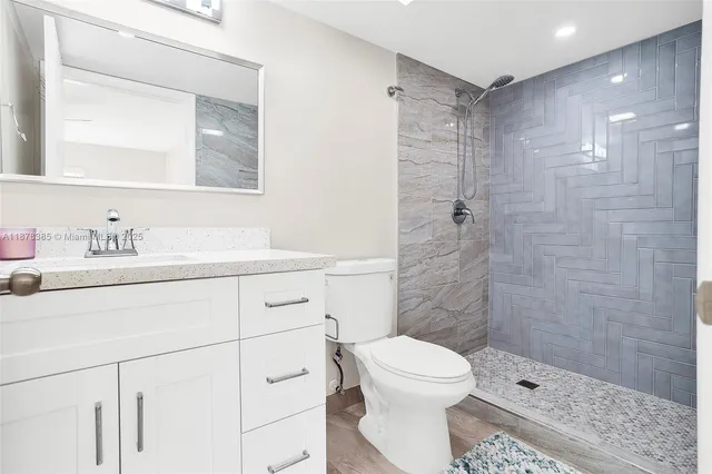 a view of a room with wooden floor and fan