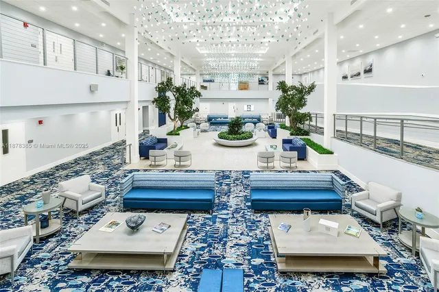 a view of a livingroom with furniture and floor to ceiling window