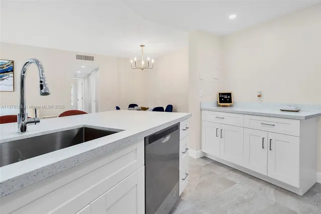 a kitchen with stainless steel appliances a refrigerator sink and cabinets