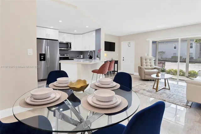 a view of a room with a table and chairs