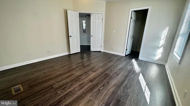 a view of hallway with wooden floor