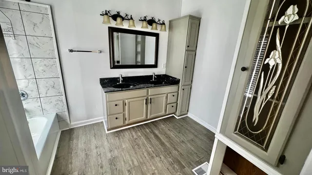 a bathroom with a sink a toilet and mirror