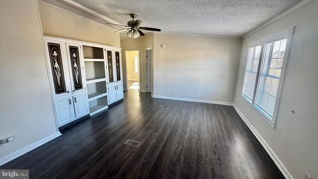 a view of a hallway with wooden floor and stairs
