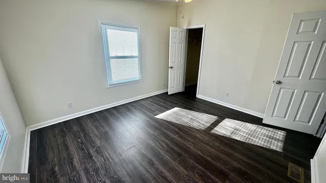 a view of wooden floor and windows in a room