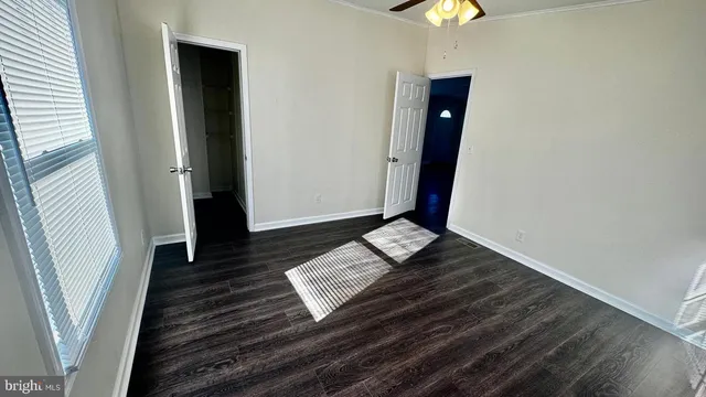 a living room with wooden floor and furniture
