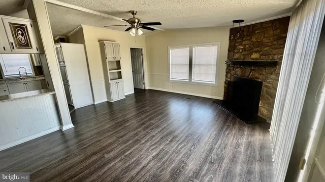 wooden floor in an empty room with a fireplace