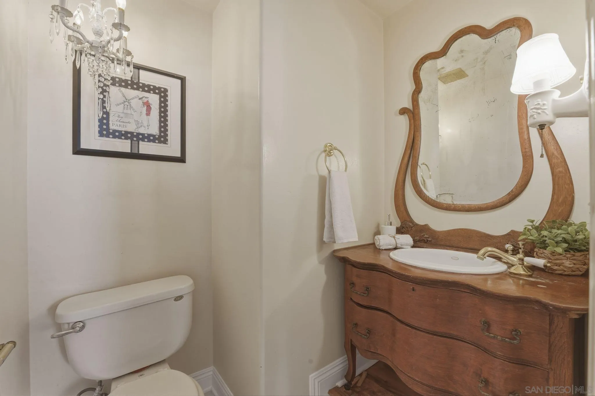 1650 Cuyamaca Avenue Spring Valley, CA 91977 - Photo 2 of 35 a bathroom with a toilet a sink and mirror