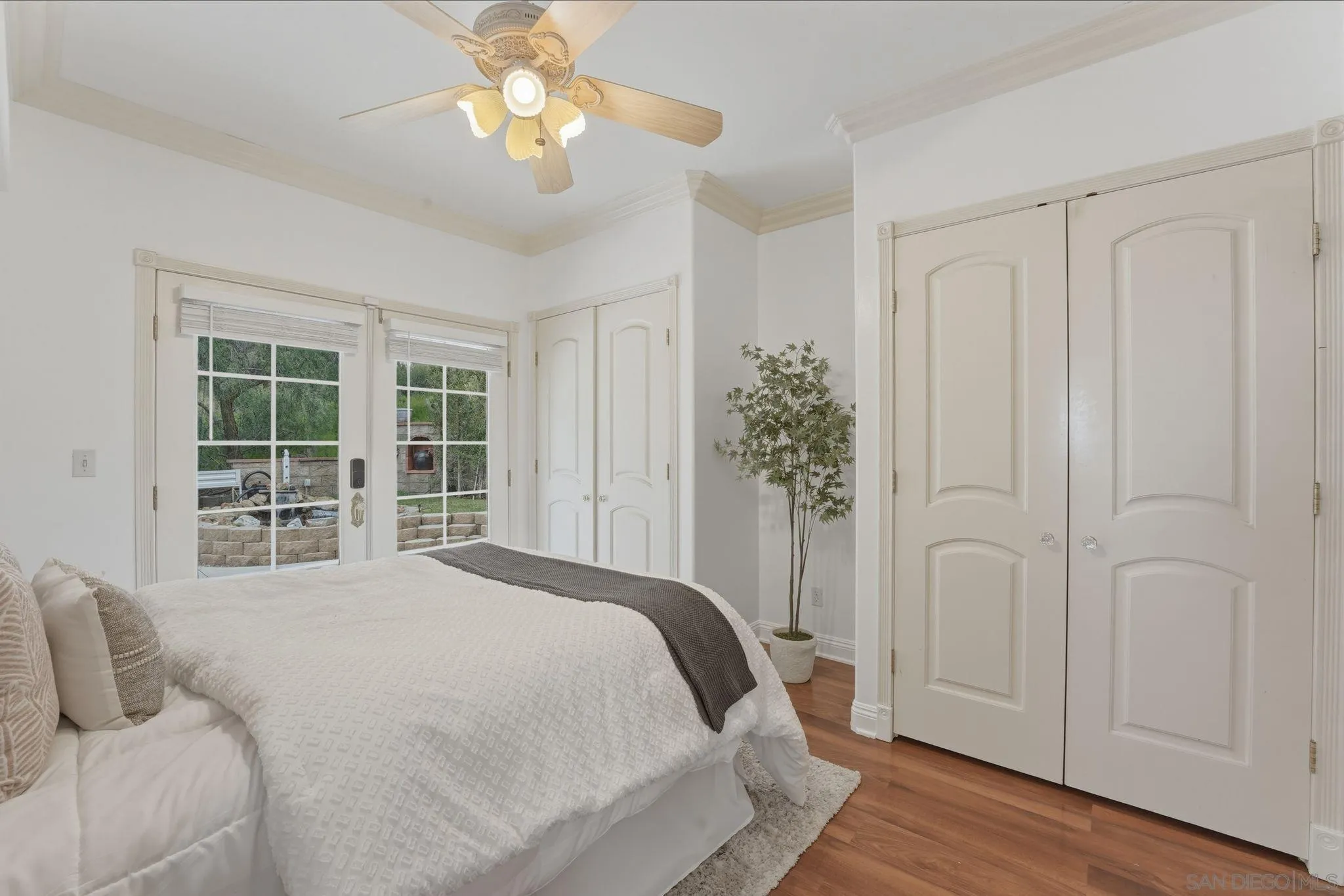 1650 Cuyamaca Avenue Spring Valley, CA 91977 - Photo 21 of 35 a spacious bedroom with a large bed and a chandelier