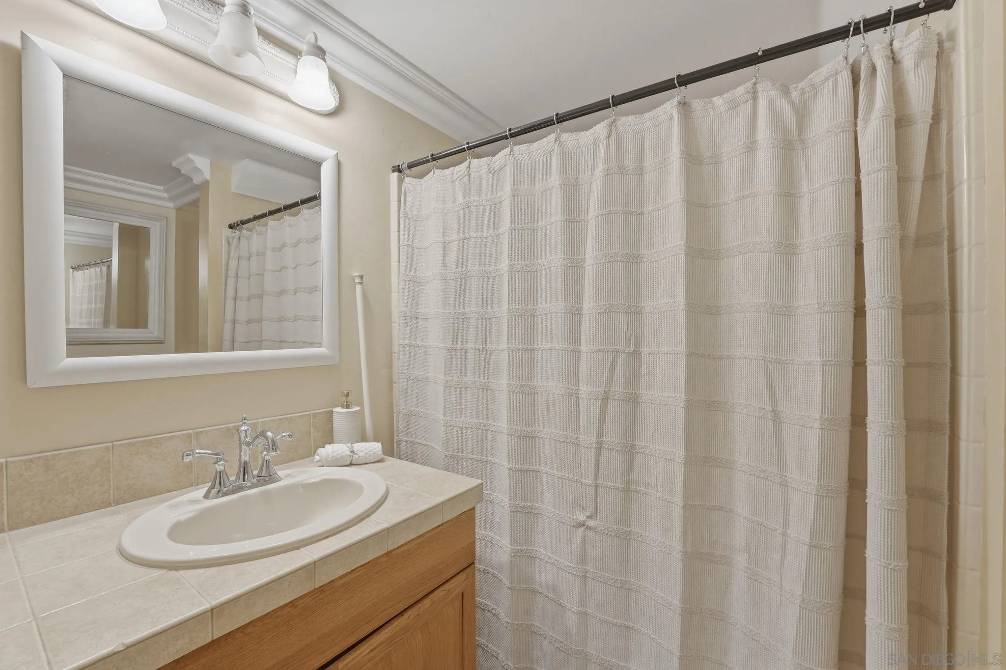 1650 Cuyamaca Avenue Spring Valley, CA 91977 - Photo 23 of 35 a bathroom with a sink and a mirror