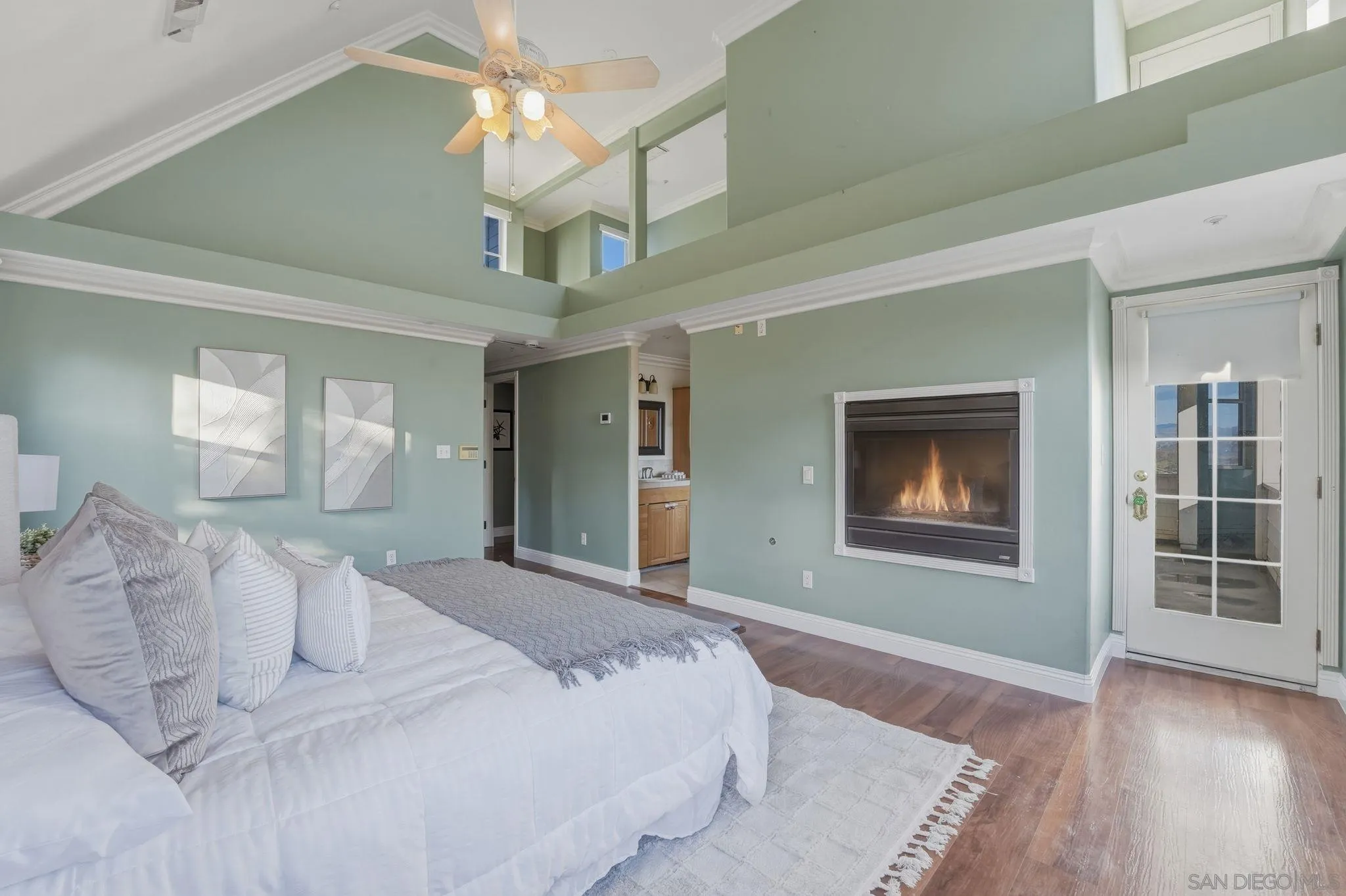 1650 Cuyamaca Avenue Spring Valley, CA 91977 - Photo 5 of 35 a bedroom with a large bed and a chandelier