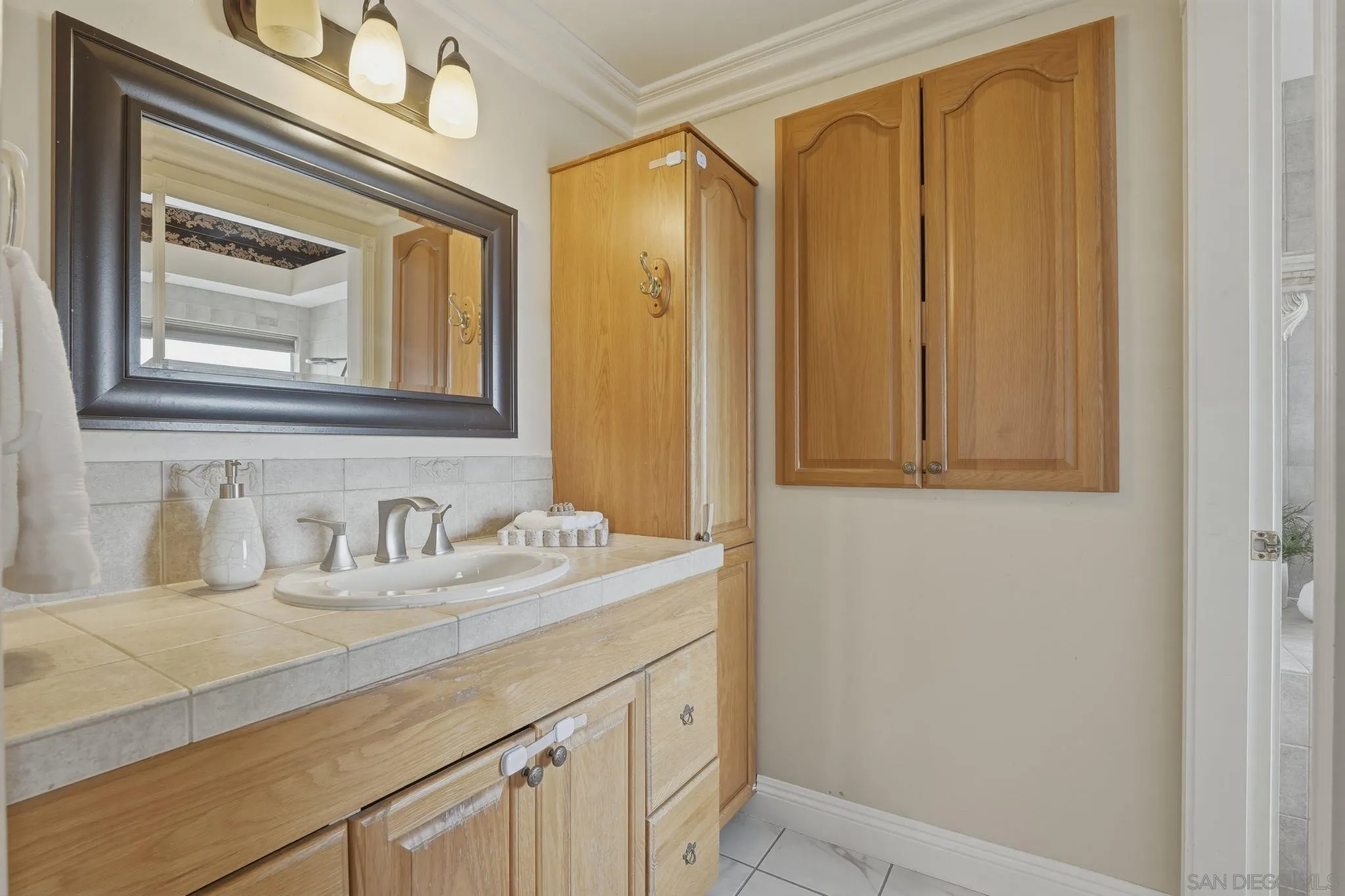 1650 Cuyamaca Avenue Spring Valley, CA 91977 - Photo 8 of 35 a bathroom with a granite countertop sink and a mirror