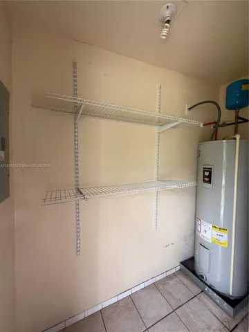 a view of storage and utility room with closet