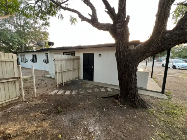 a view of a house with a tree and a big yard