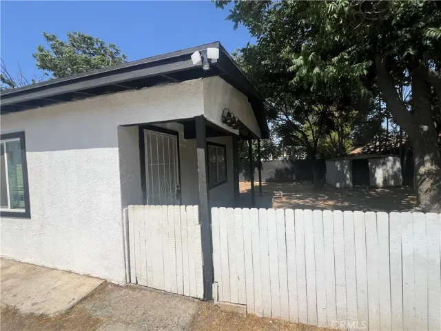 a view of a wooden house with a large tree