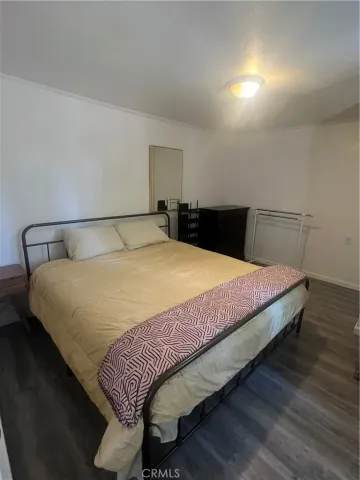 a large bed sitting in a bedroom next to a cabinet