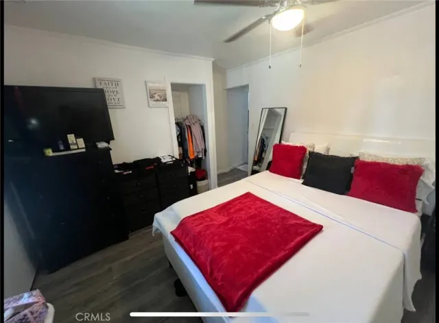 a bed room with a bed and a television