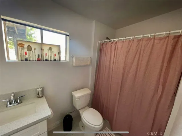 a white toilet sitting next to a bathroom sink