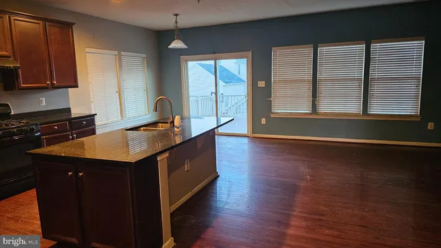a view of room with window and wooden floor