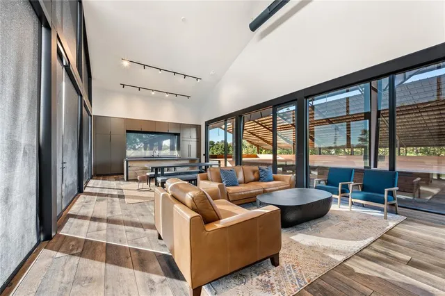 a living room with fireplace furniture and a floor to ceiling window