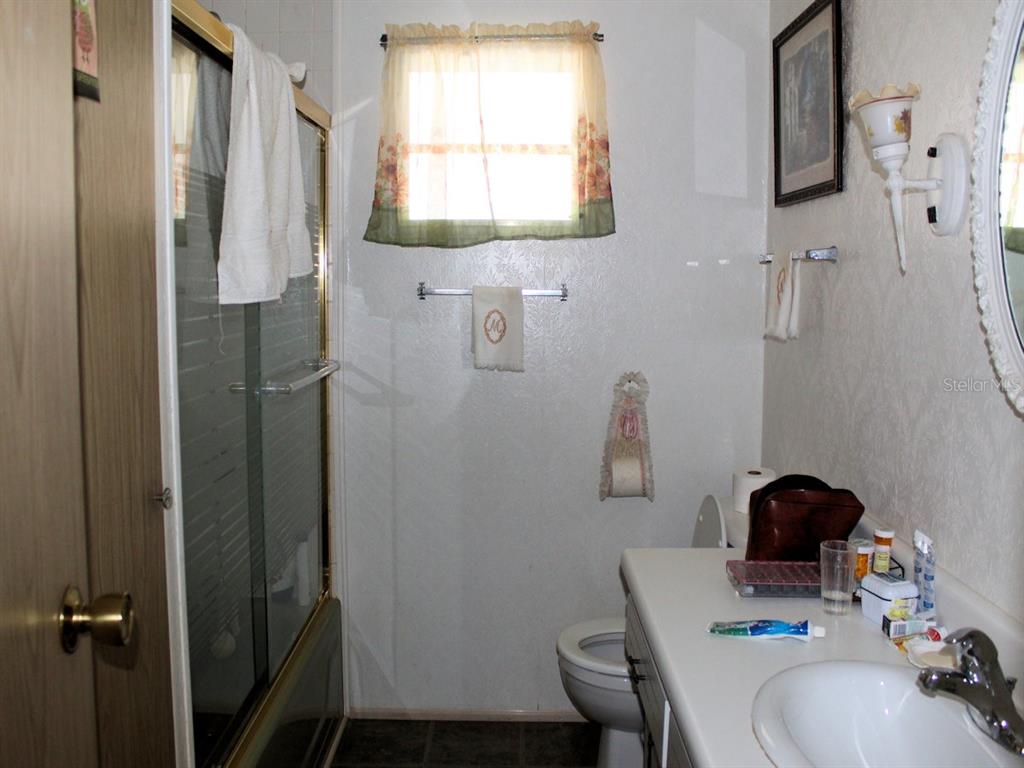 55 Thatch Palm Street West Largo, FL 33770 - Photo 11 of 14 a bathroom with a sink toilet and a mirror