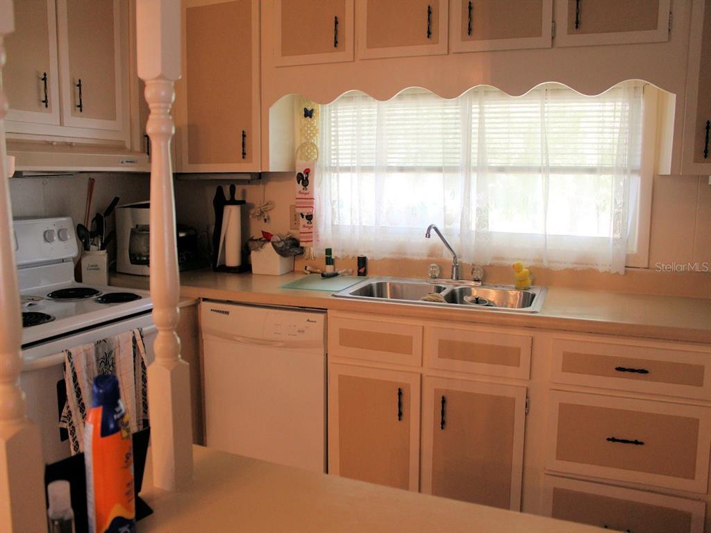 55 Thatch Palm Street West Largo, FL 33770 - Photo 3 of 14 a kitchen with appliances cabinets and a window