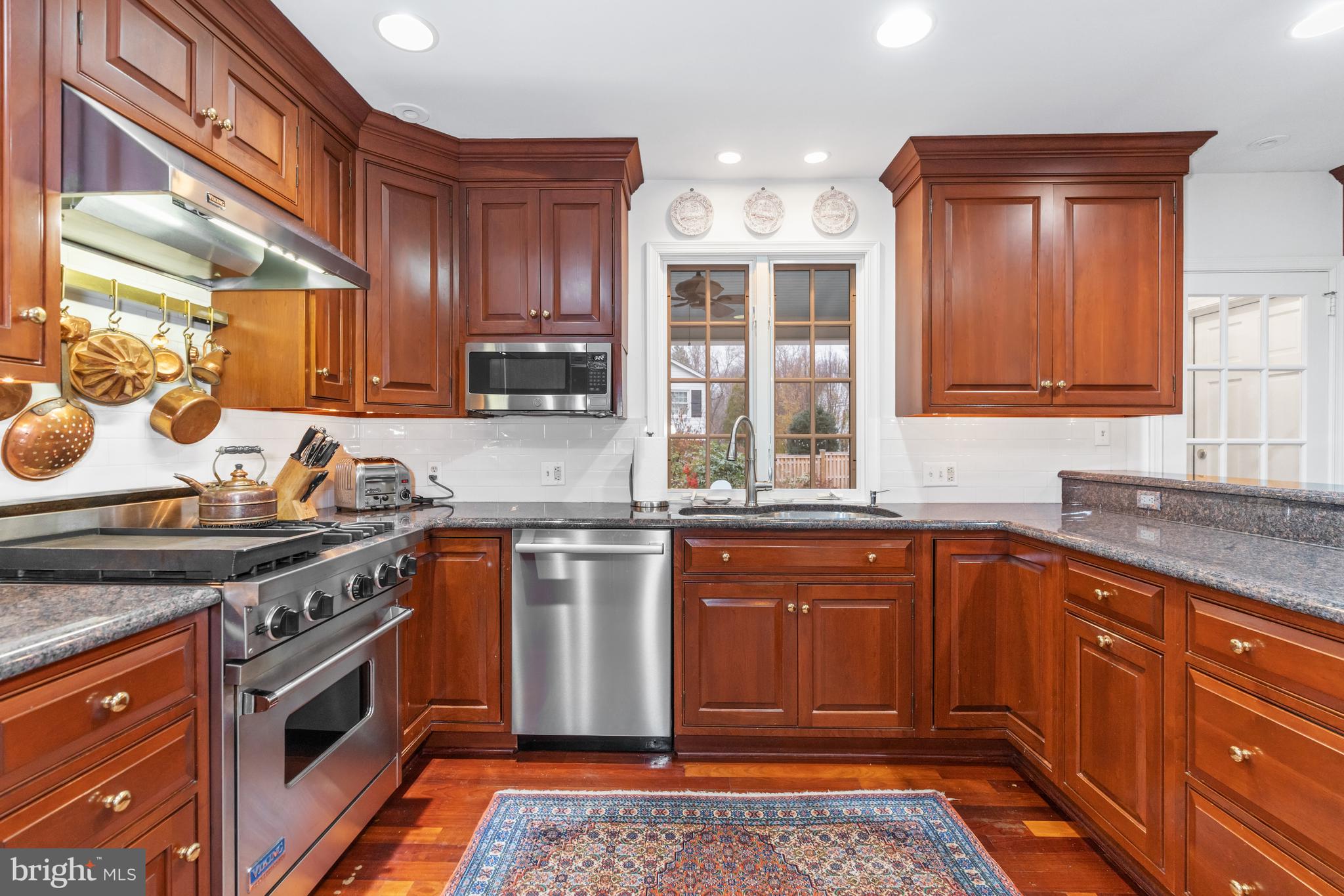 901 Stuart Road Wilmington, DE 19807 - Photo 14 of 58 Kitchen with cherry cabinets and tile backsplash