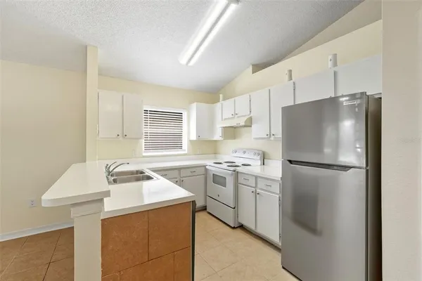 a kitchen with a refrigerator a stove a sink dishwasher and a refrigerator