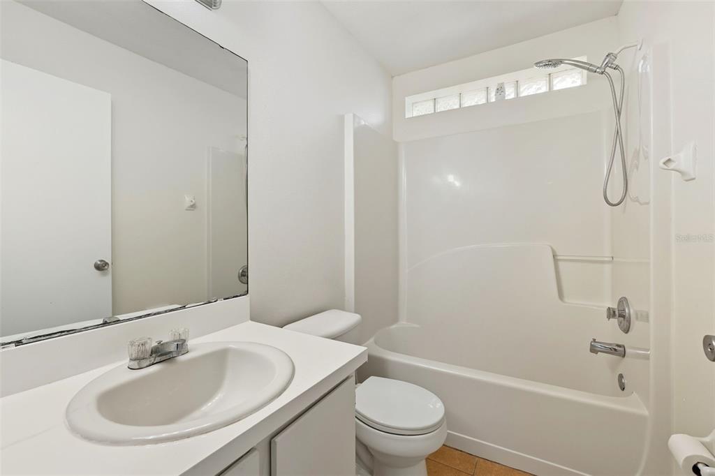 1148 Golden Gate Avenue Orlando, FL 32808 - Photo 18 of 26 a bathroom with a sink toilet and shower