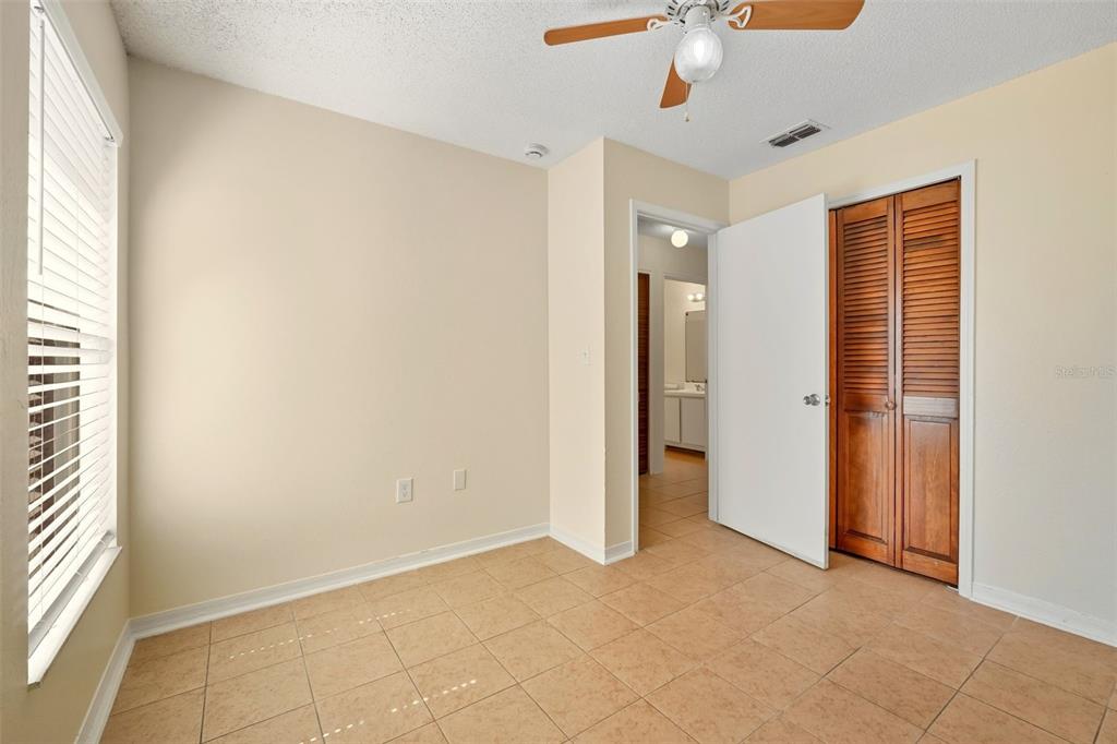 1148 Golden Gate Avenue Orlando, FL 32808 - Photo 22 of 26 an empty room with closet and a chandelier fan