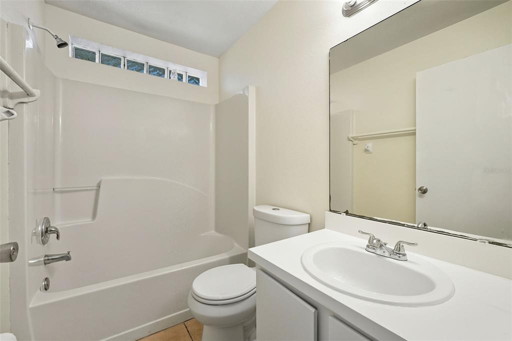 1148 Golden Gate Avenue Orlando, FL 32808 - Photo 23 of 26 a bathroom with a sink toilet and shower