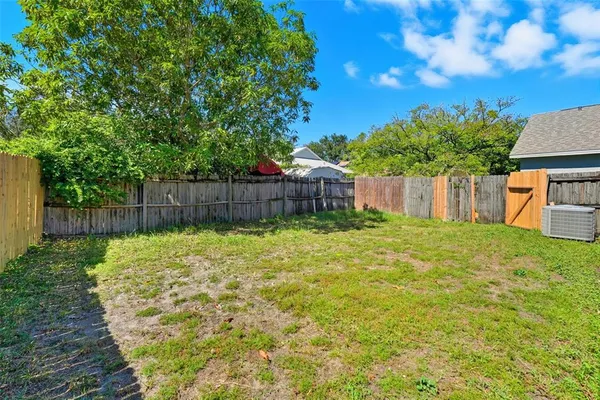 a backyard of a house with table and chairs