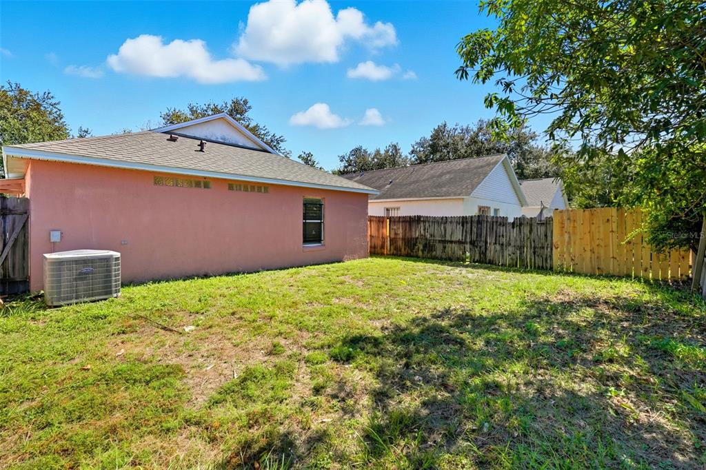 1148 Golden Gate Avenue Orlando, FL 32808 - Photo 25 of 26 a backyard of a house with table and chairs