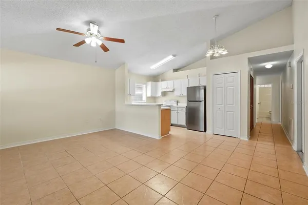 a view of a kitchen with a sink and refrigerator
