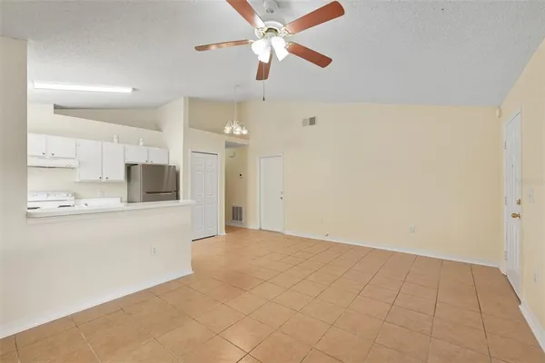 a view of a kitchen with a sink and a refrigerator